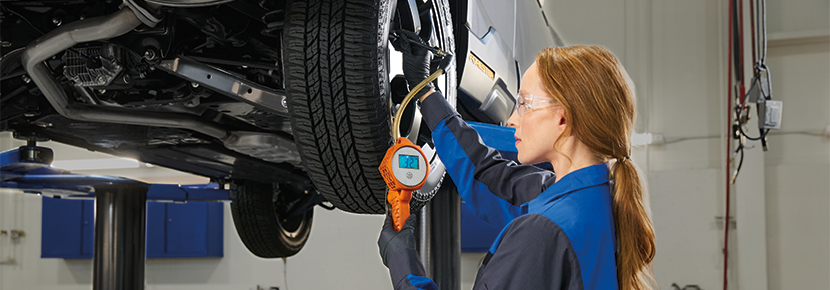 A Subaru technician checking tire pressure. | Burke Subaru in Cape May Court House NJ
