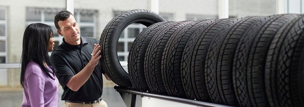 Subaru service representative showing customer a tire. | Burke Subaru in Cape May Court House NJ